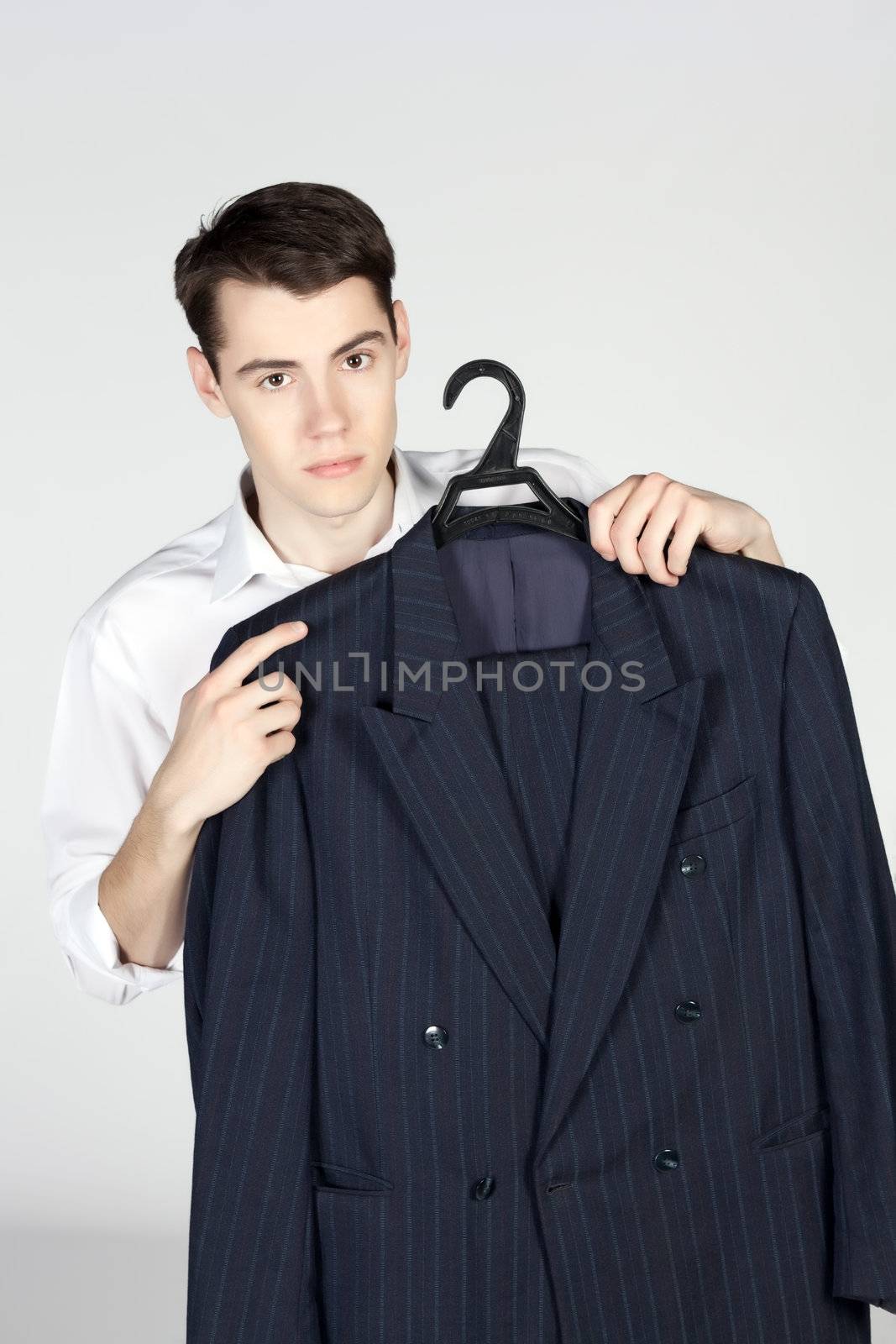 young man with a suit on hanger on white background