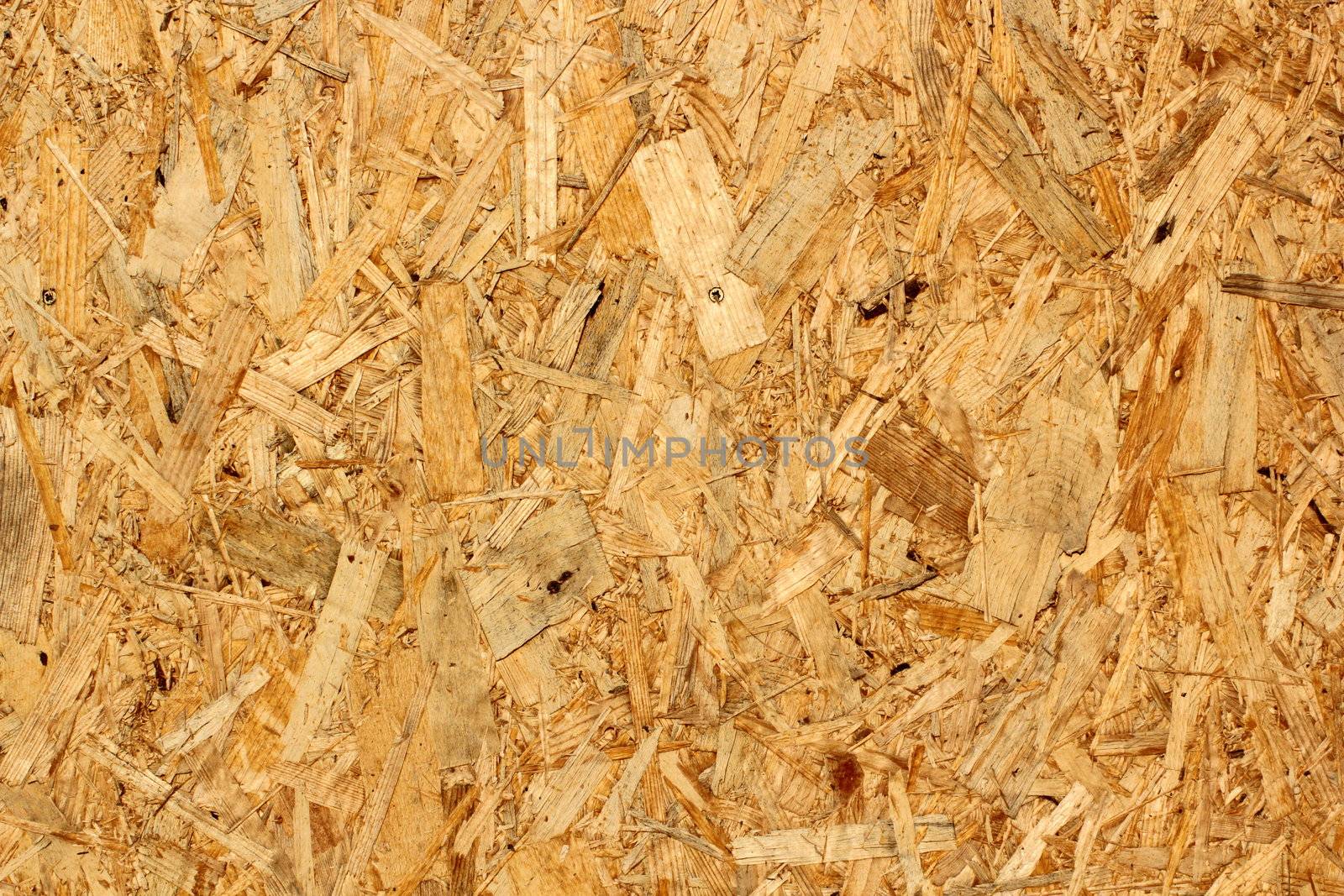 texture of oriented strand board at the exterior of an unfinished house