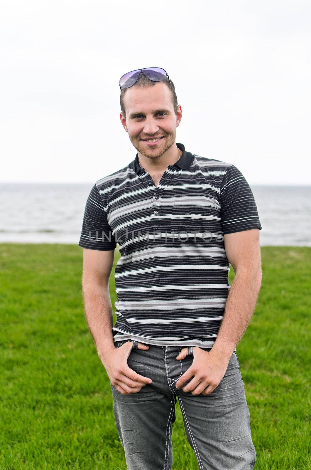 Handsome smiling man near the seaside.
