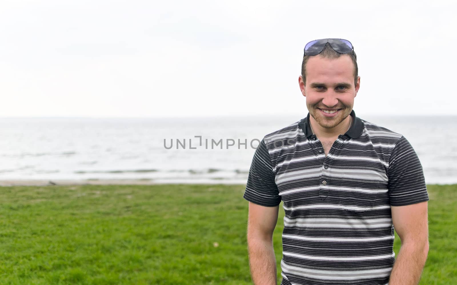 Handsome smiling man near the seaside.