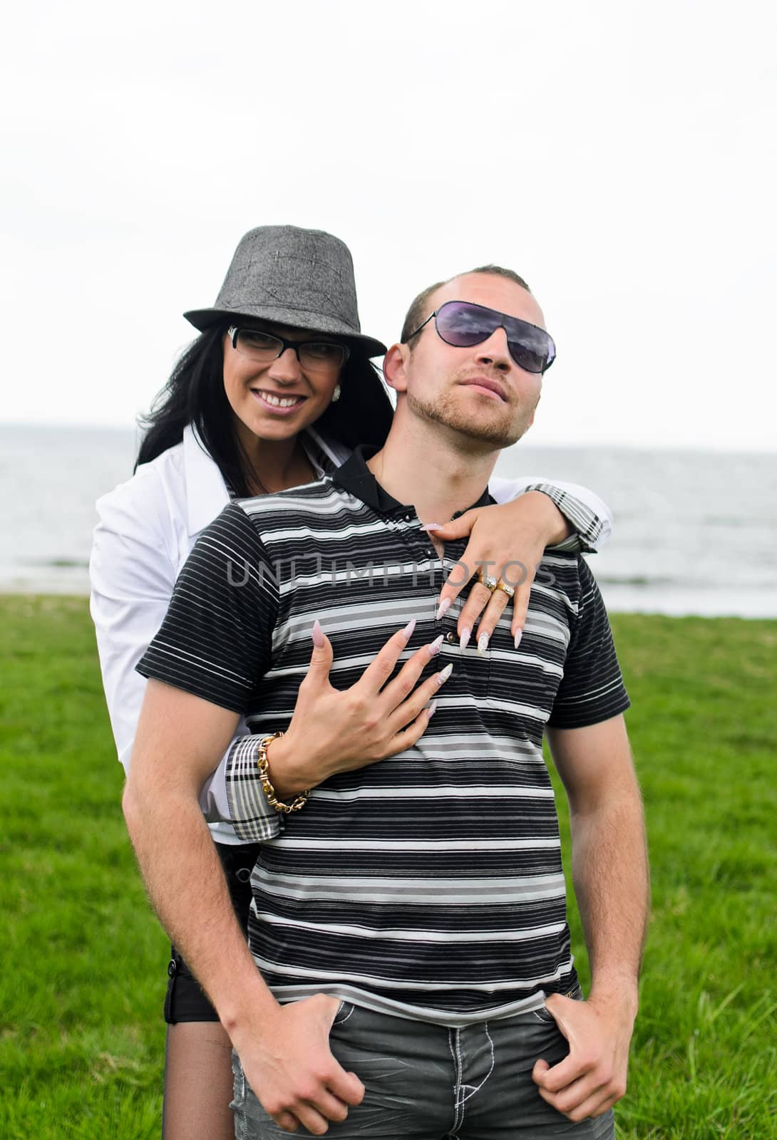 Portrait of a smiling couple by the sea by dmitrimaruta