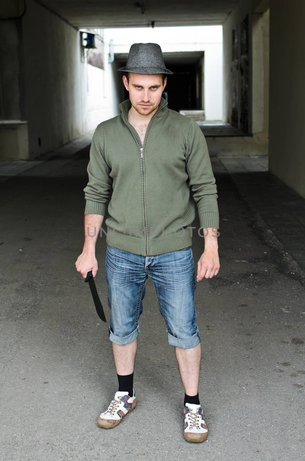 Portrait of a street bandit with knife in hand.