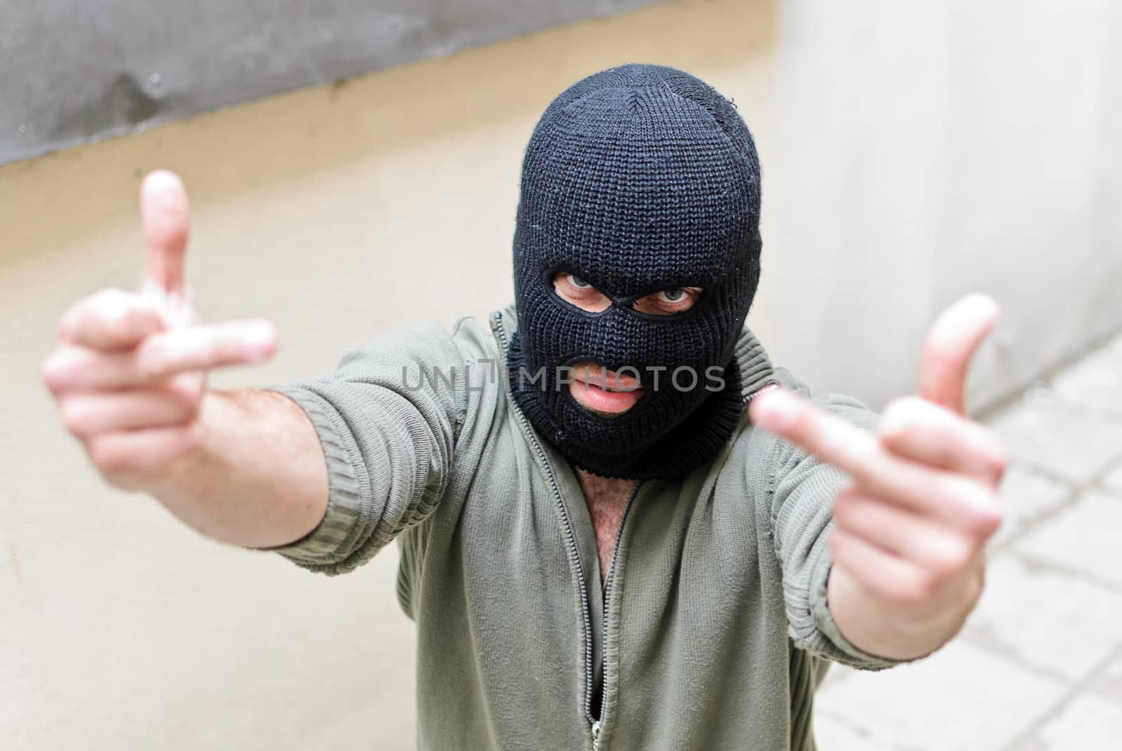 Burglar wearing a mask shows fuck gesture.