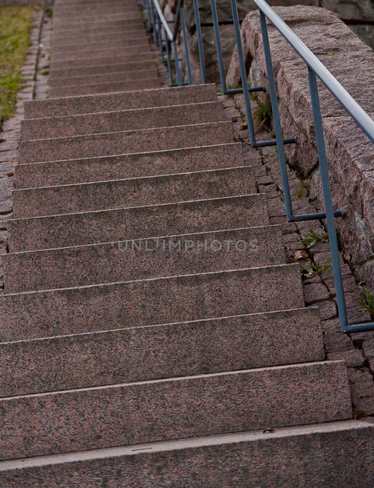Rock stairs with a metallic rail