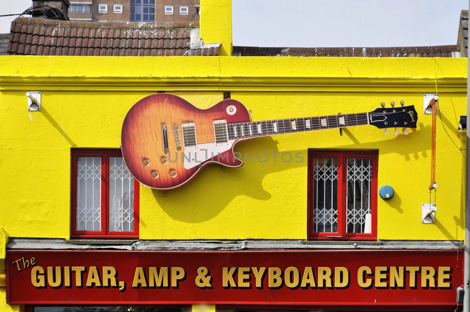 Fake Gibson Les Paul on the facade of the Guitar, Amp & Keyboard Centre in Brighton, England, UK