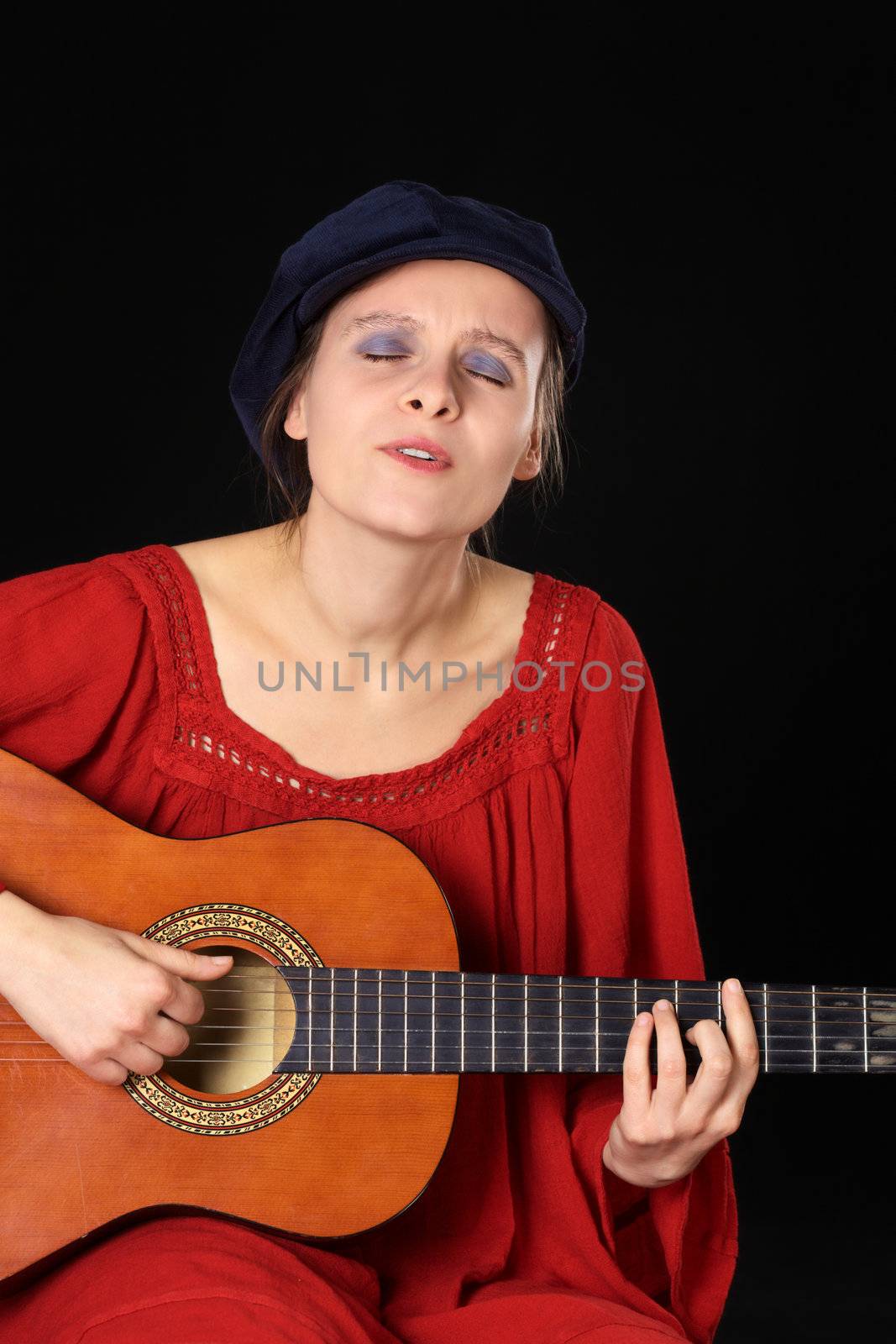 Young Caucasian Woman Singing and Playing the Guitar  by sven