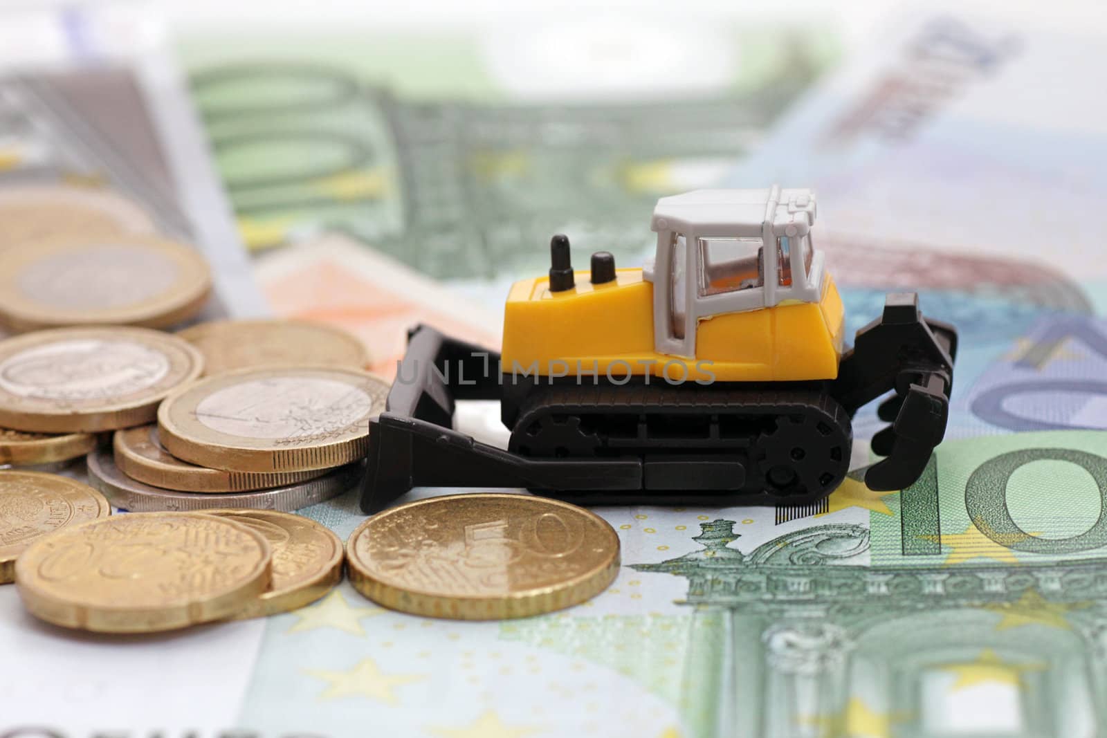 tractor rakng coins on euro banknotes