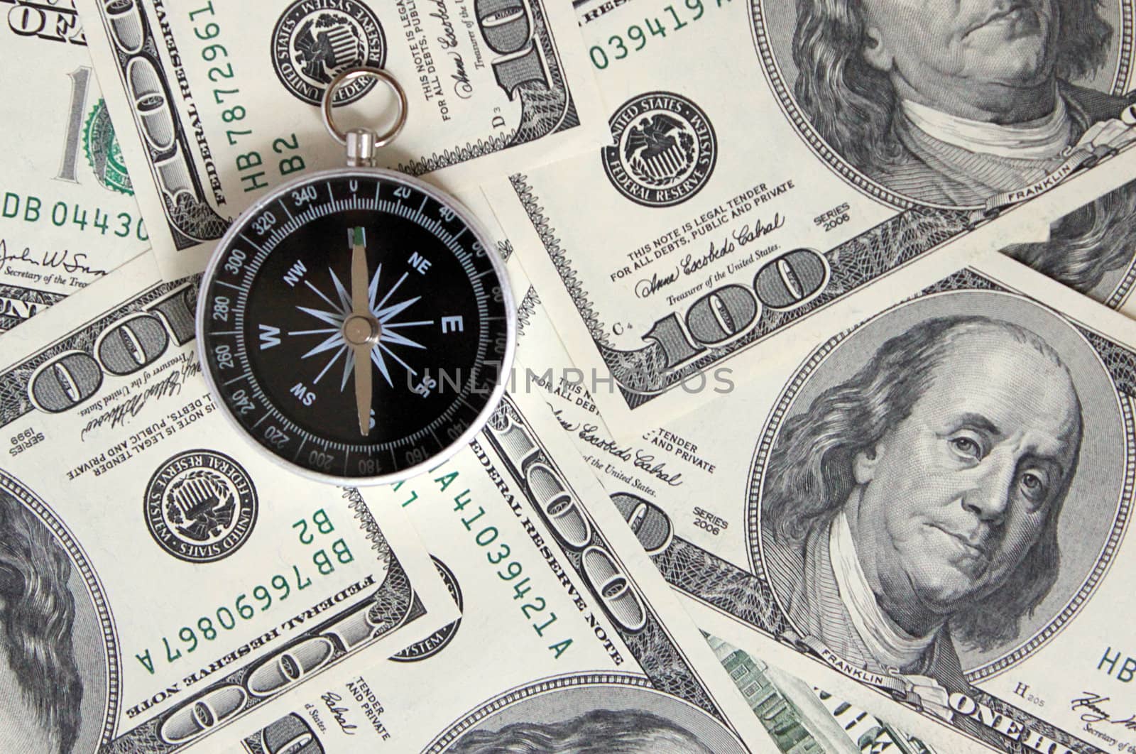 compass on cash (100 dollars banknotes)