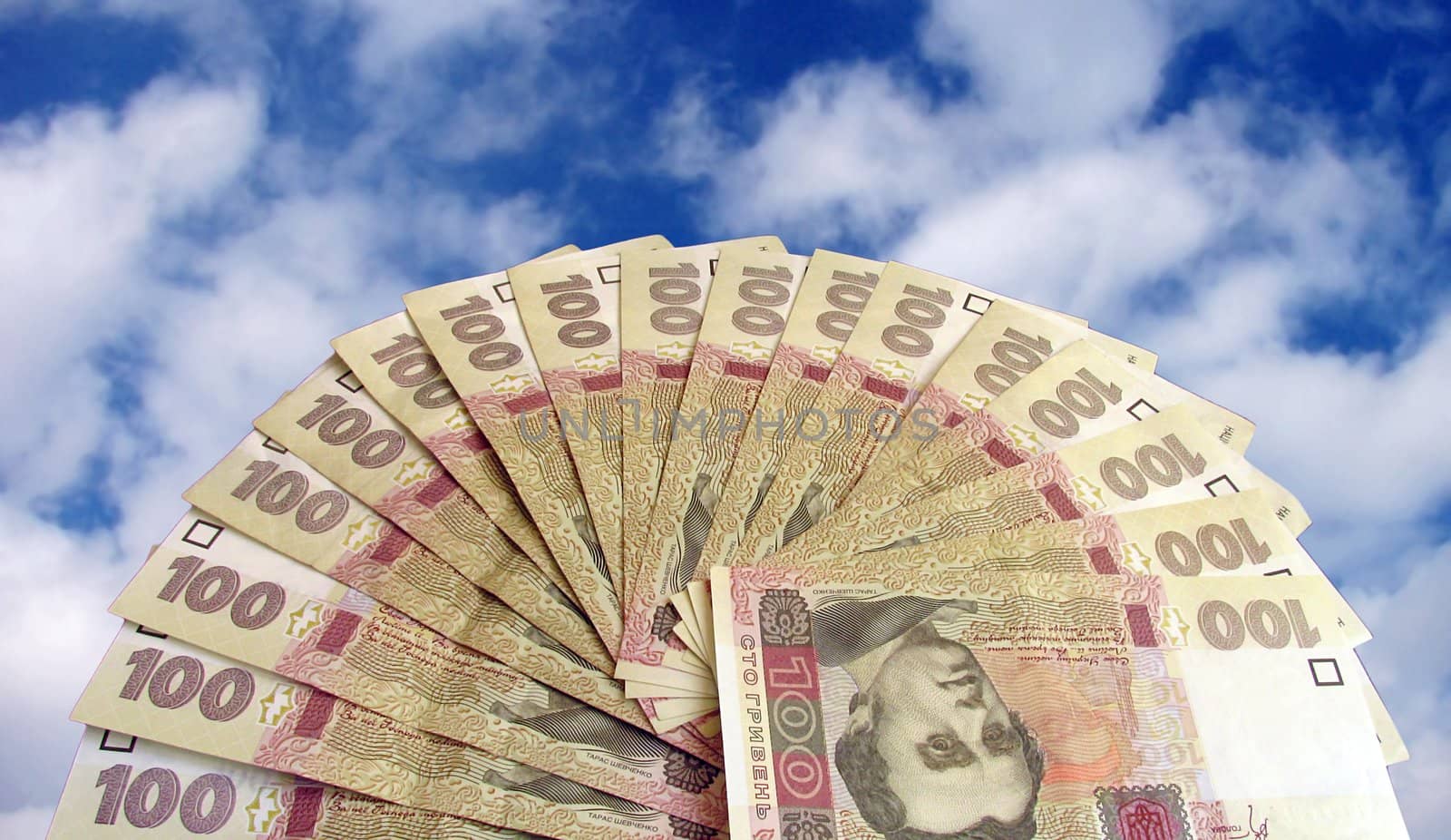 fan-shaped money (100 hrivna) over   sky