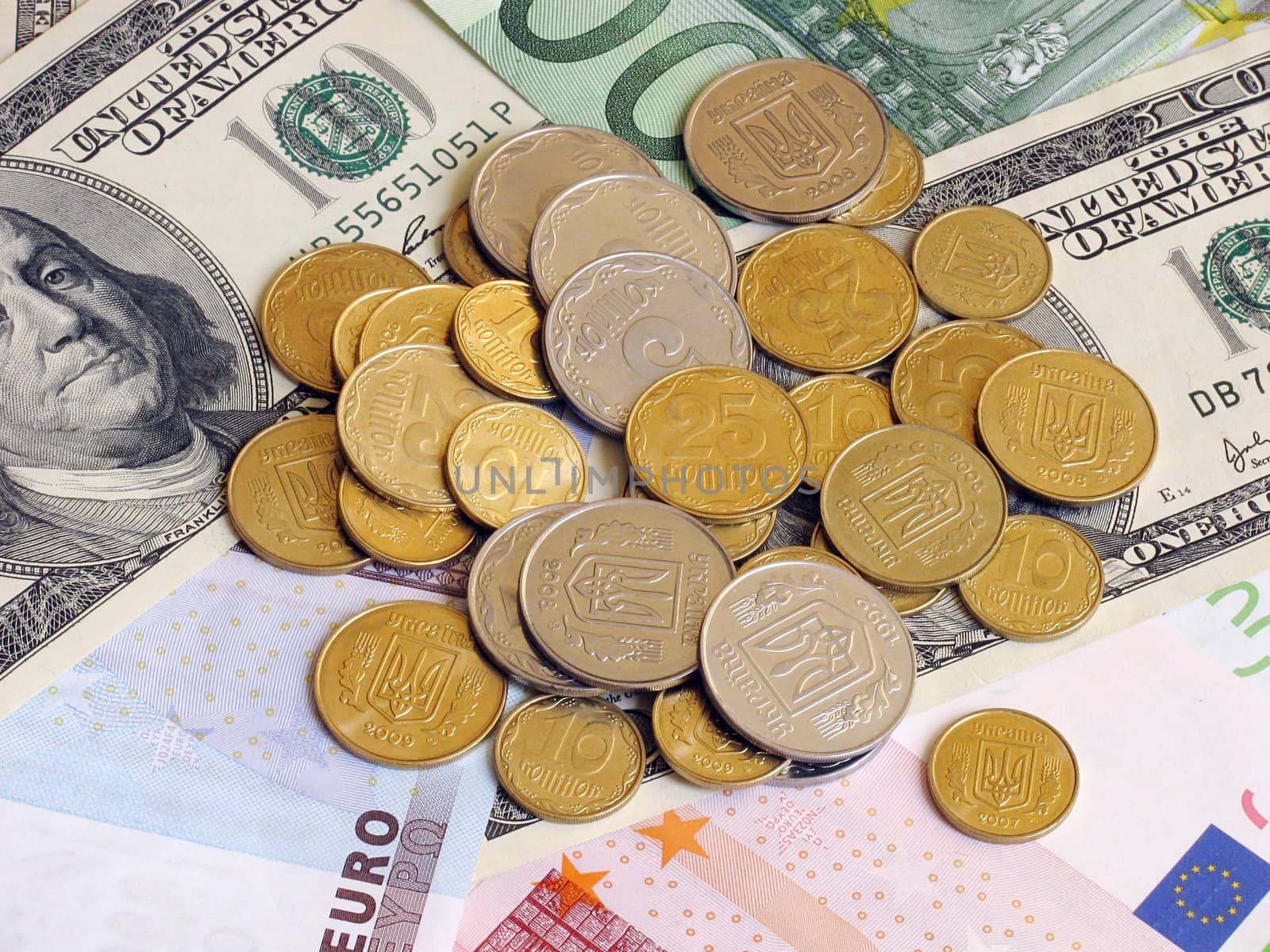 heap of coins on banknotes