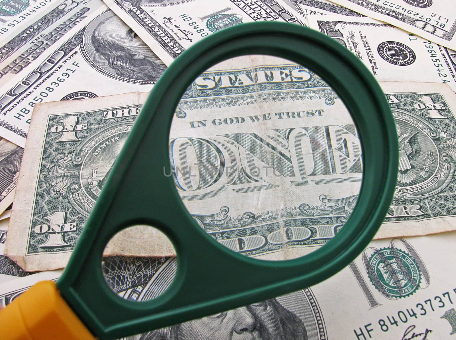 Title One on one dollar banknote through magnifying glass