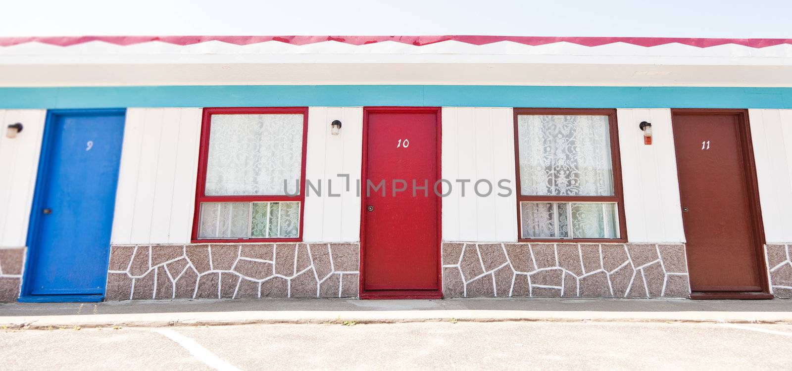 Motel with red and blue doors by aetb