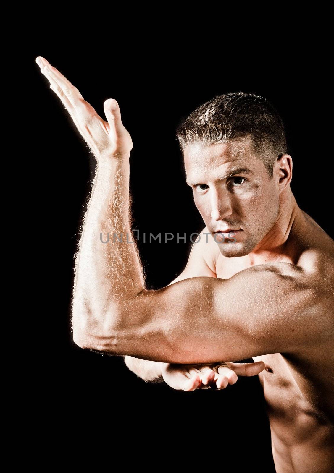 Muscular man isolated on black background