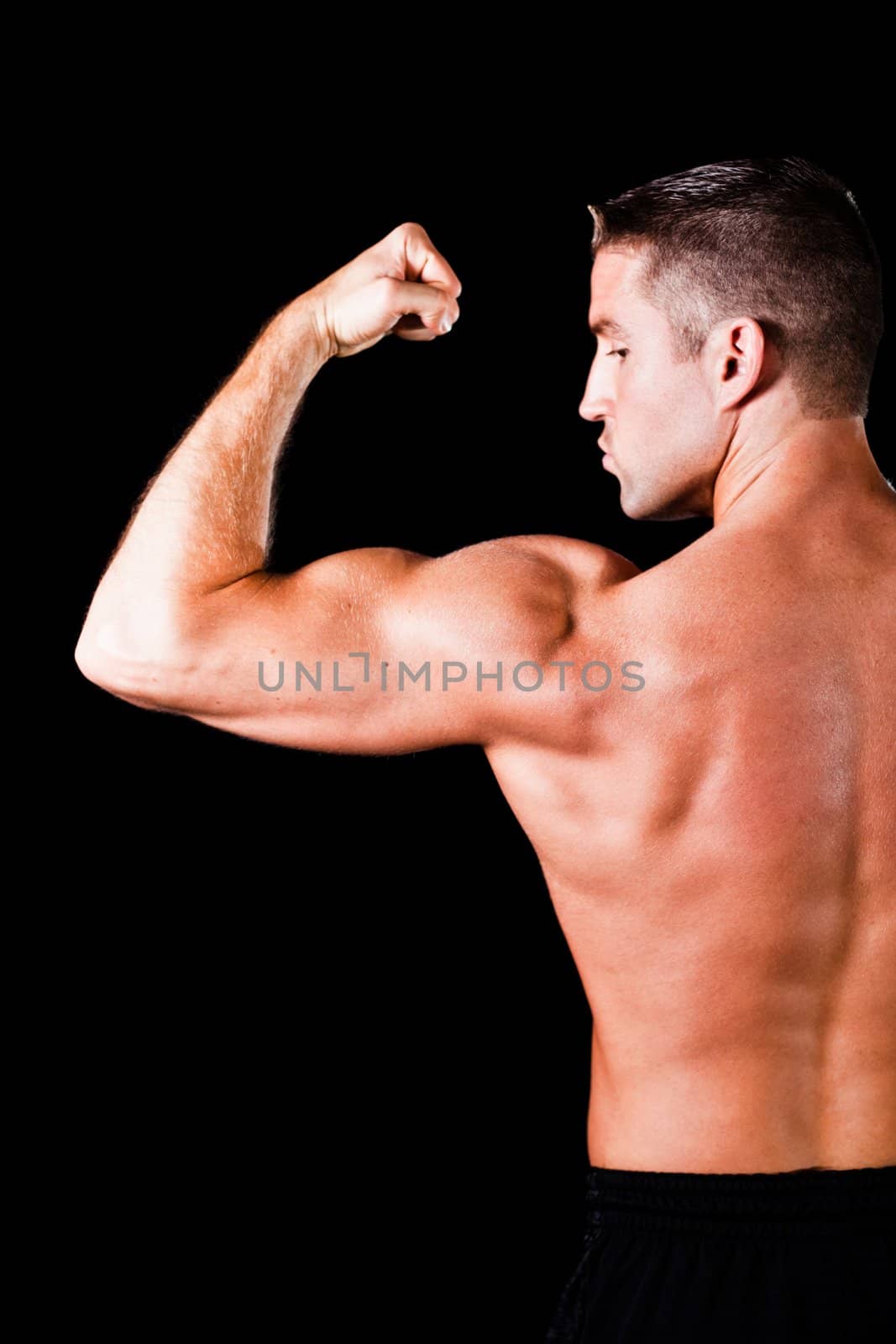 Muscular man isolated on black background