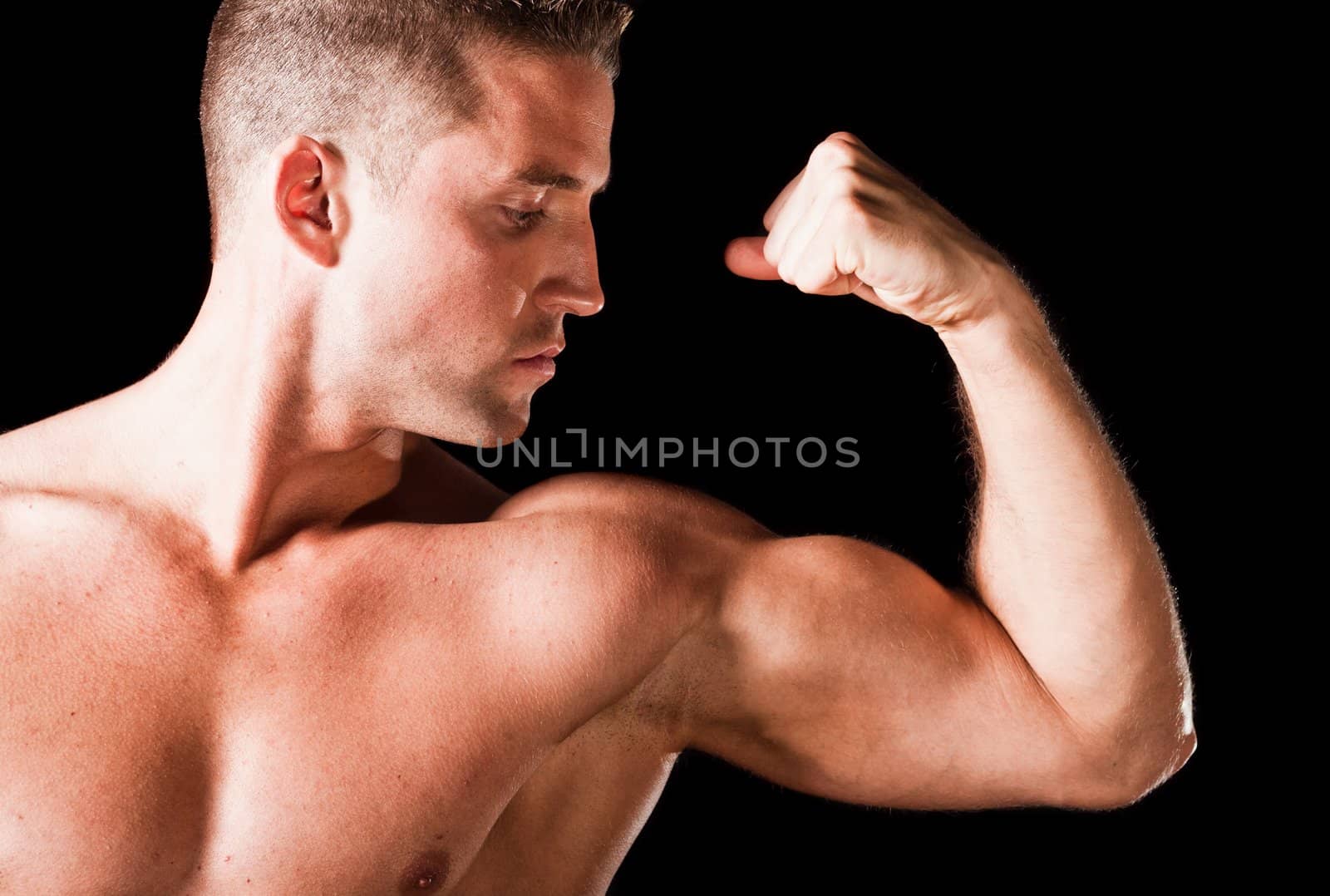 Muscular man isolated on black background