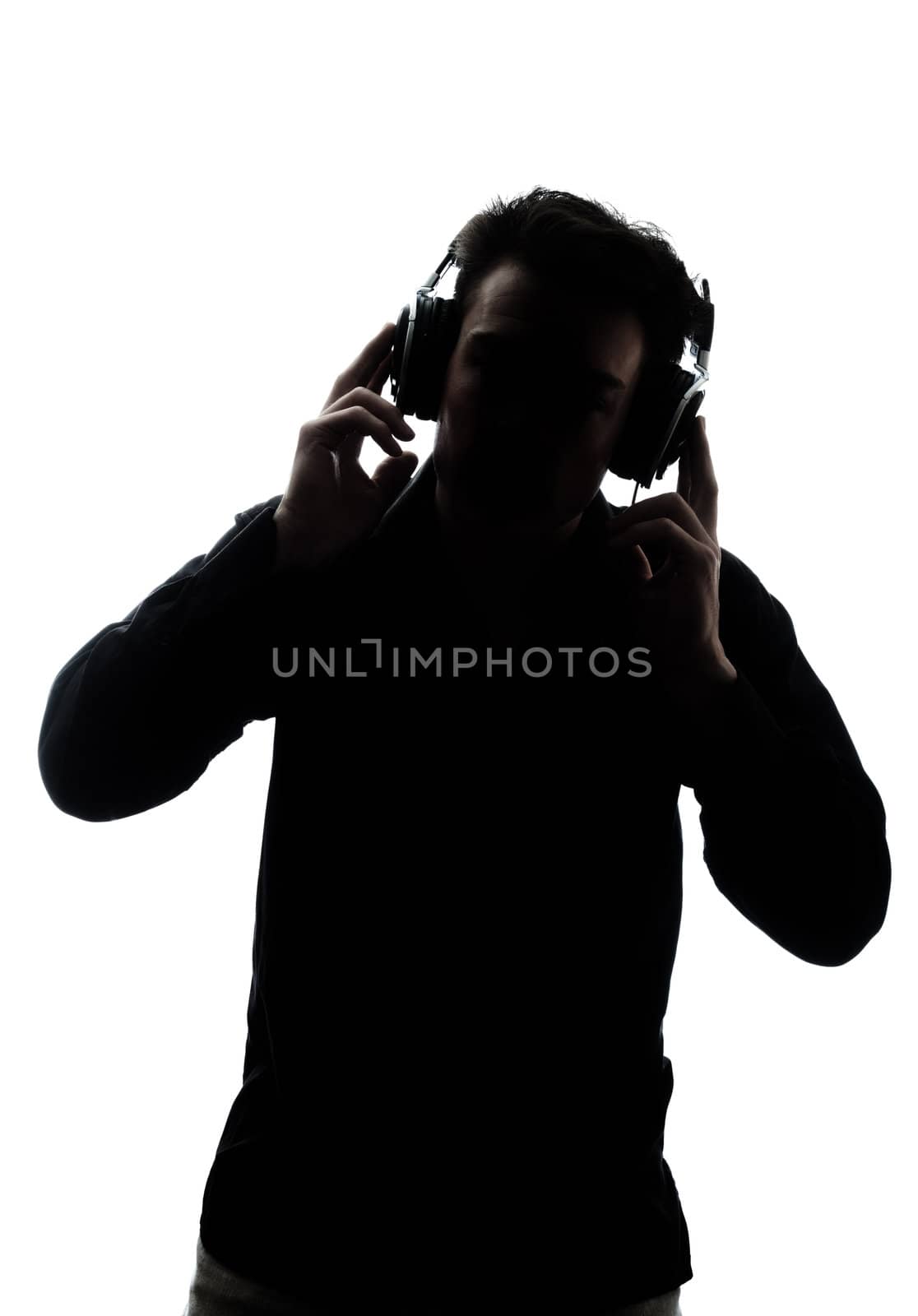 Male in silhouette listening to headphones isolated on white background