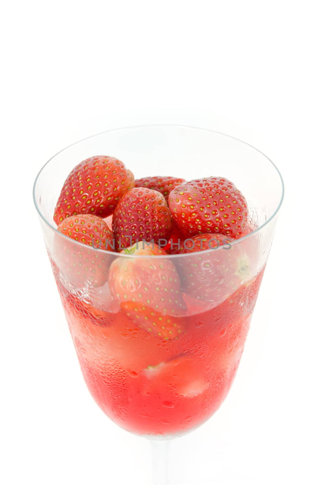 close up red  strawberry juice in glass over white