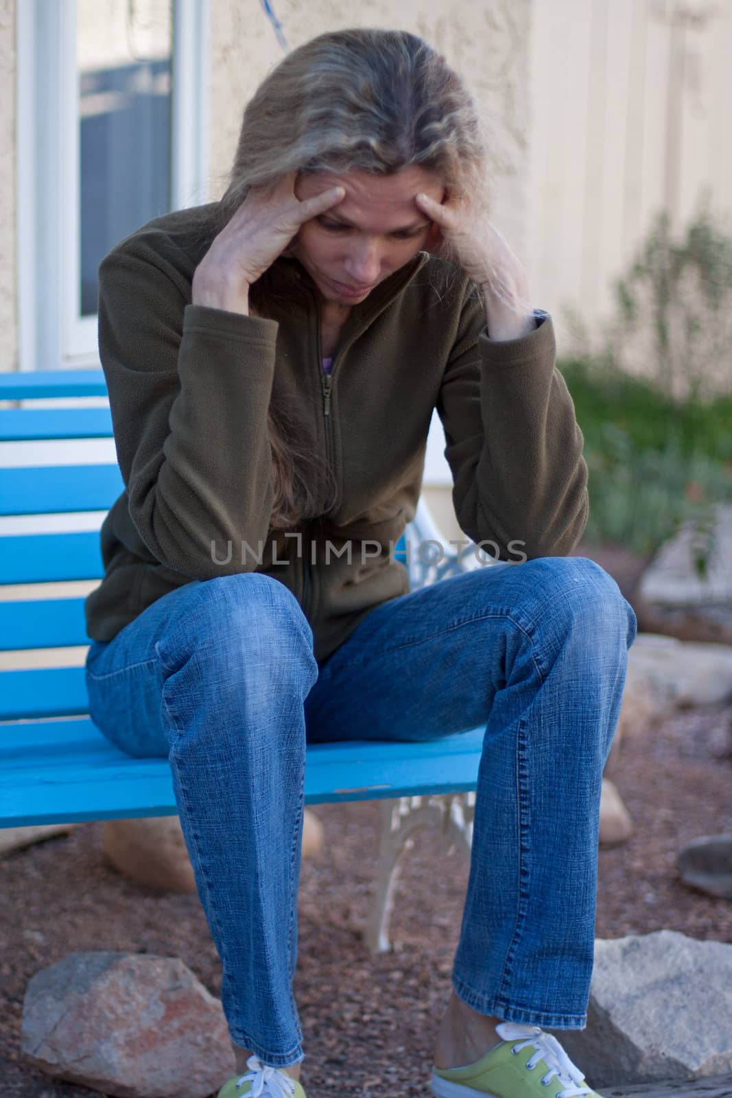 Woman sitting on bench depressed and frustrated