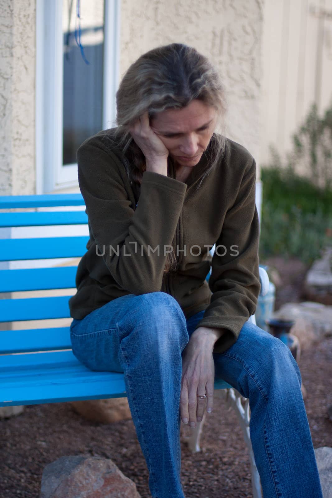 Woman sitting on bench depressed and frustrated