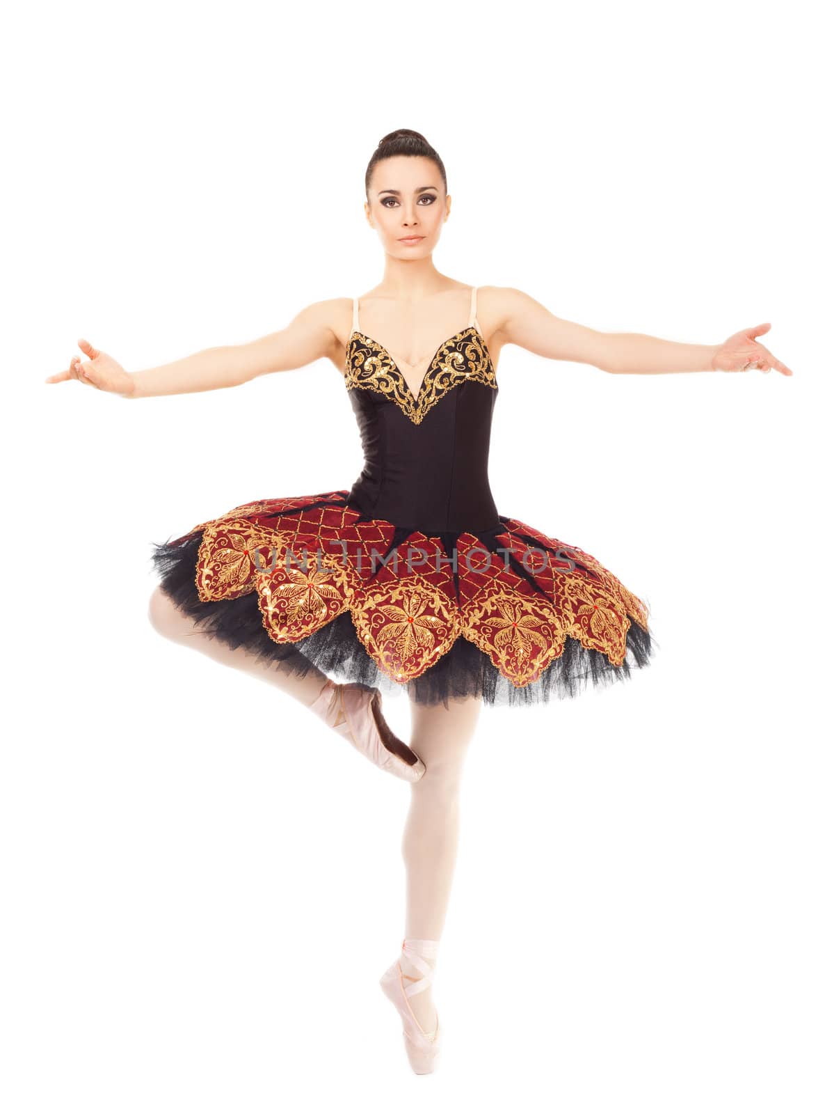 Beautiful female ballerina practicing in tip toe position on white background