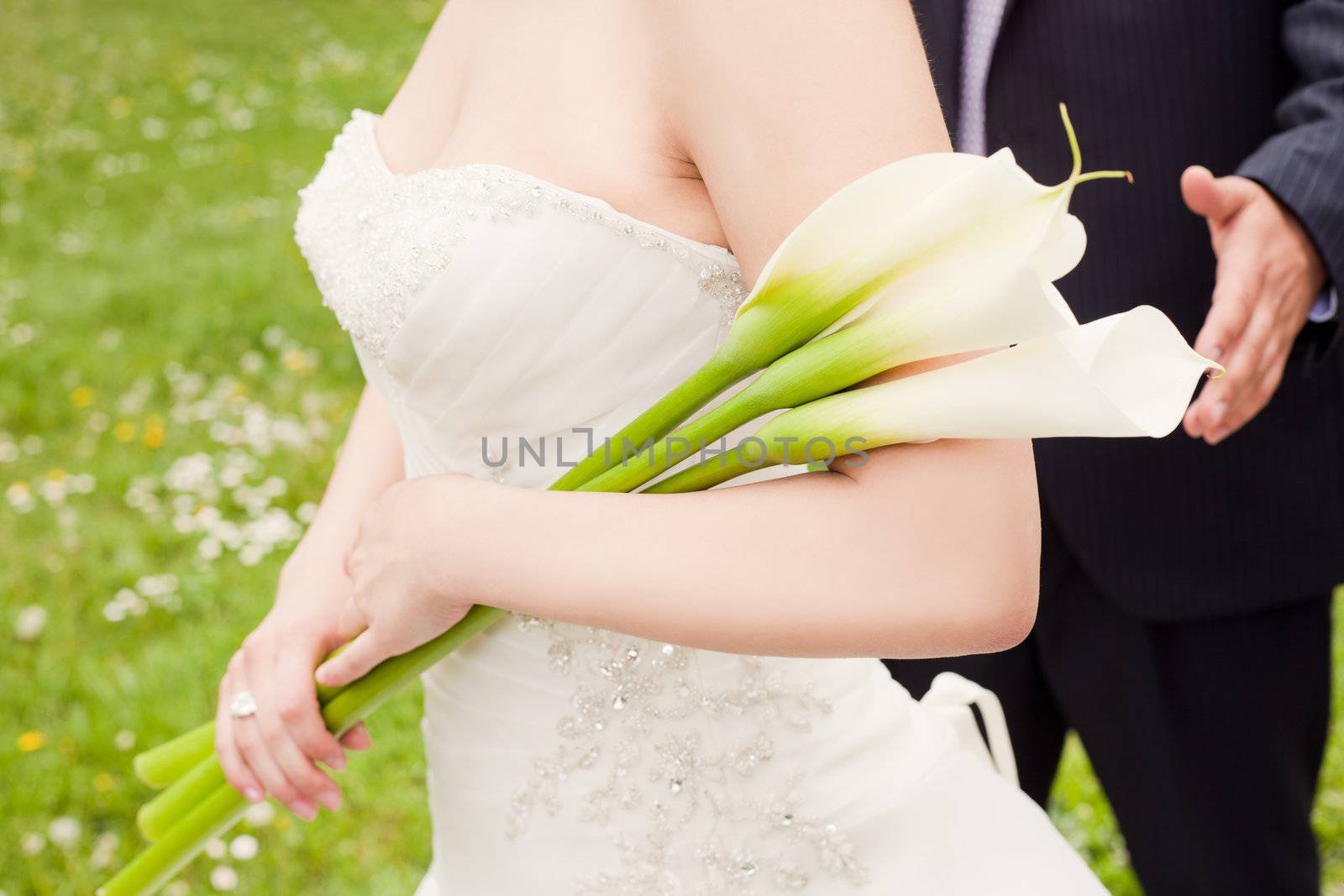Bride holding flowers by vilevi