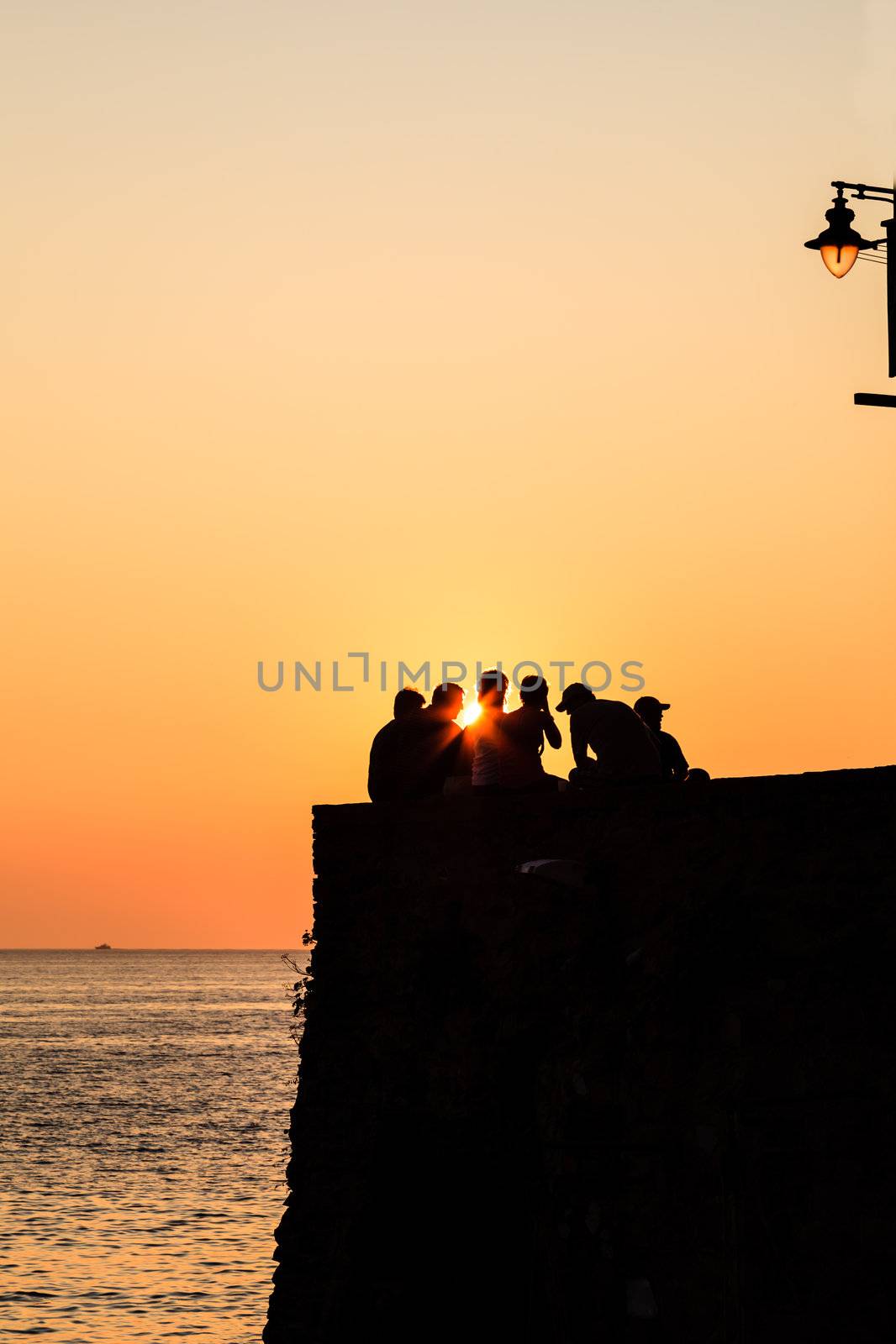 Group of People Watching Sunset in Riomaggiore, Italy