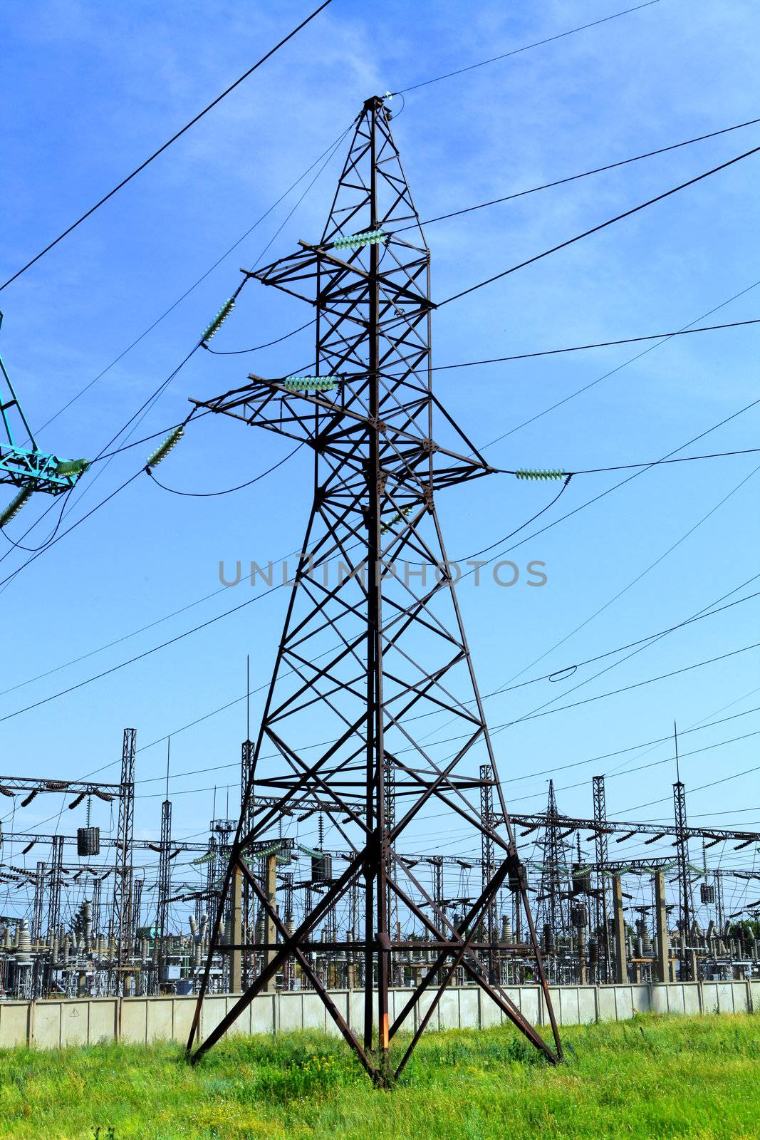 High-tension power line with clouds on background