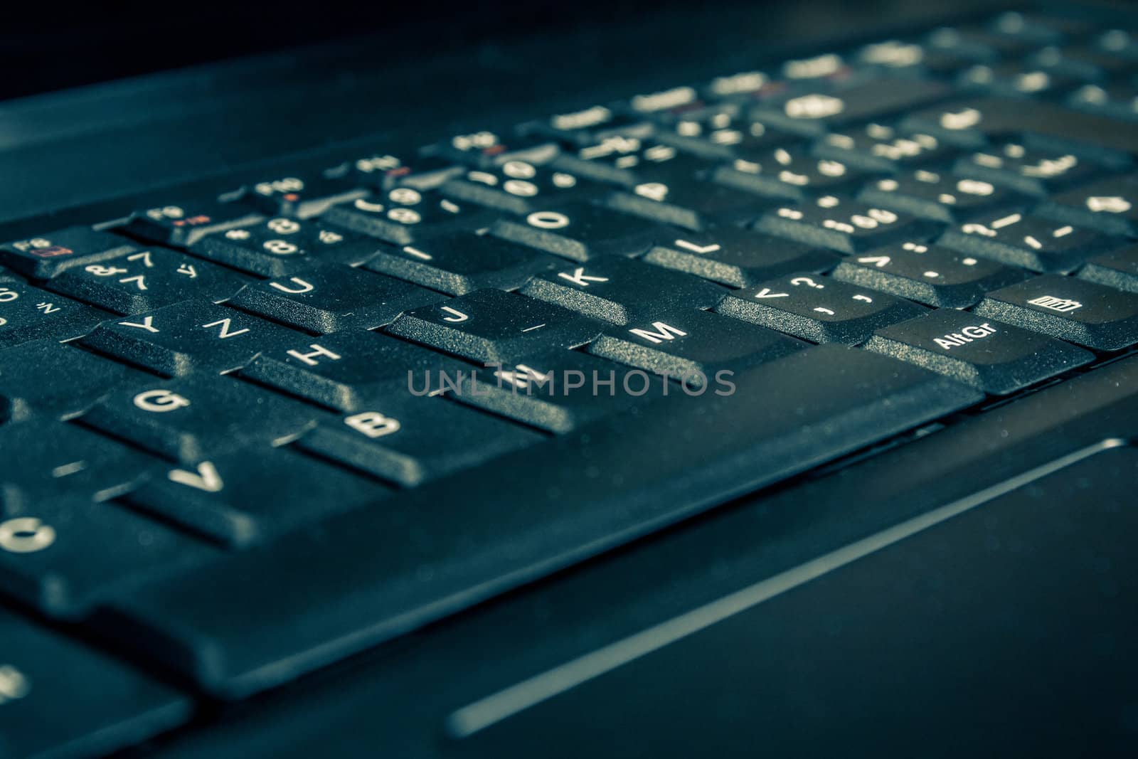 close up of toned laptop keyboard with shallow focus