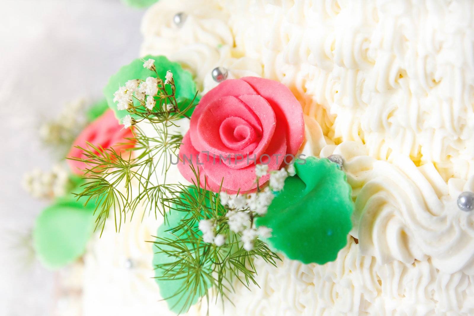 Detail of traditional wedding cake with cream roses