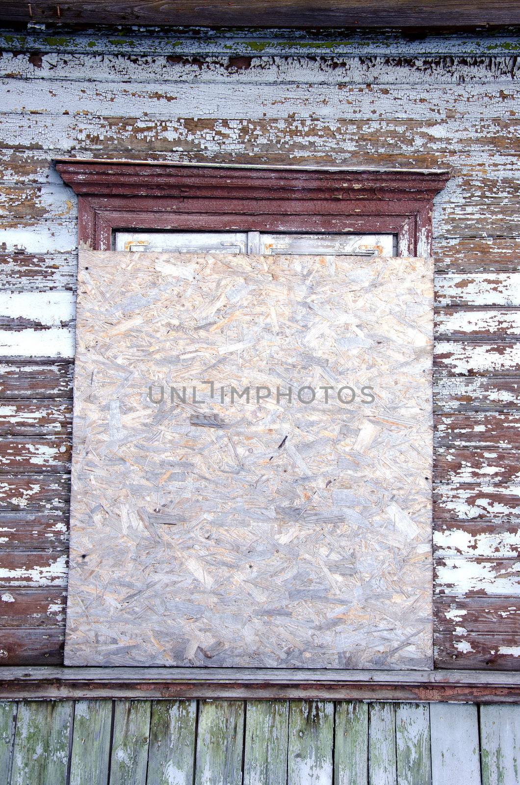 Abandoned house window nailed-up wood chipboard by sauletas