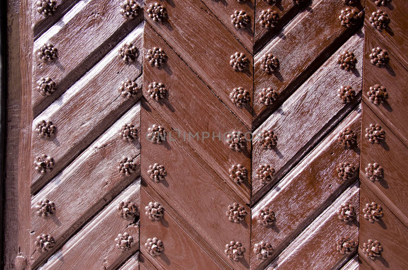 Background of ancient retro wooden door. Brown painted decorated old style door.