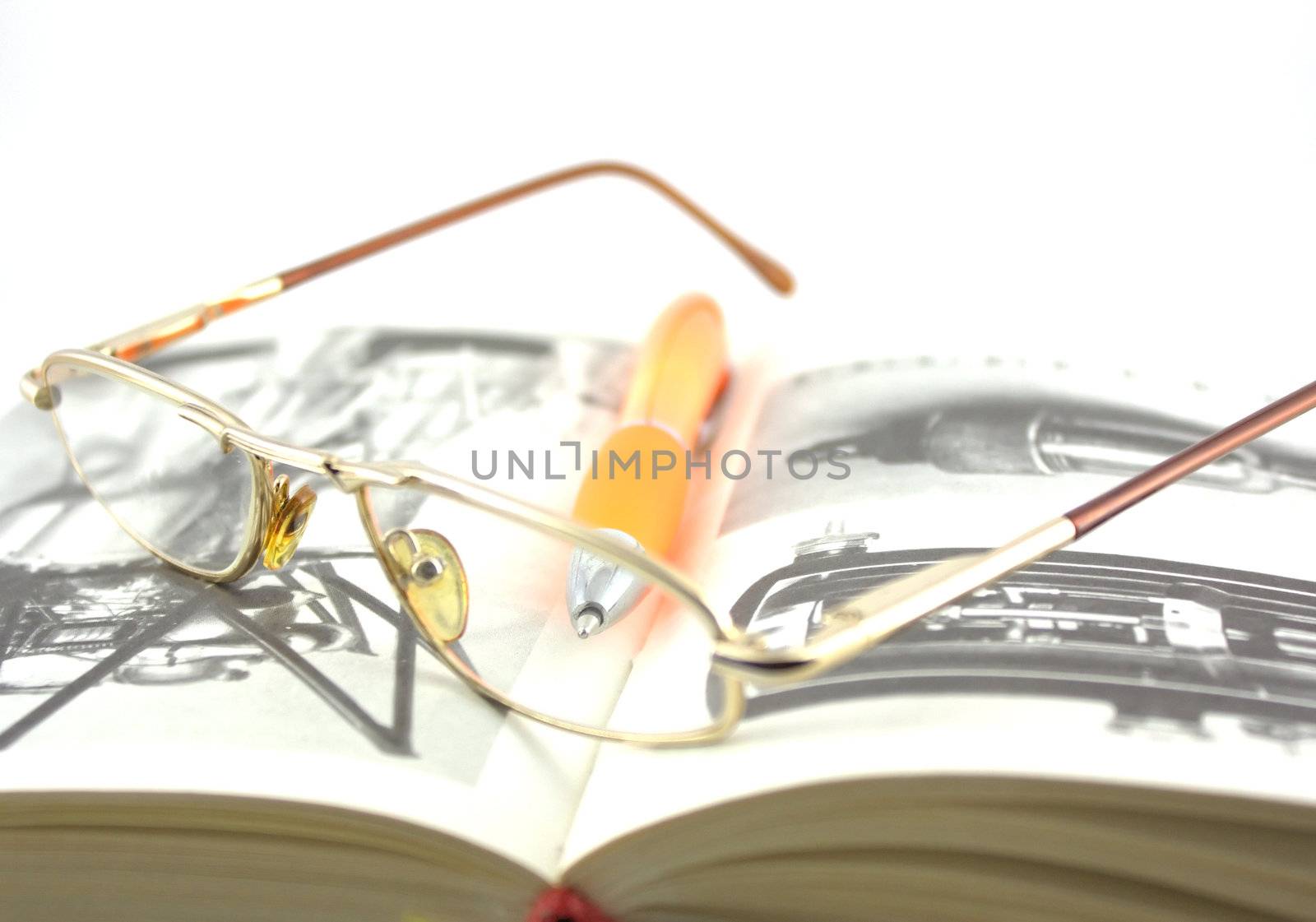 Old book, glasses and pen. Shallow DOF.