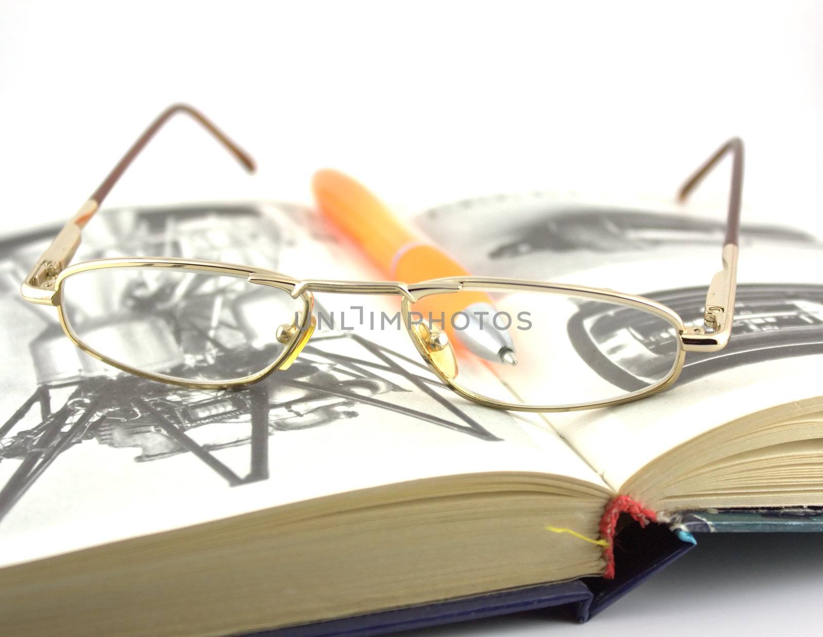 Old book, glasses and pen. Shallow DOF. by sergpet