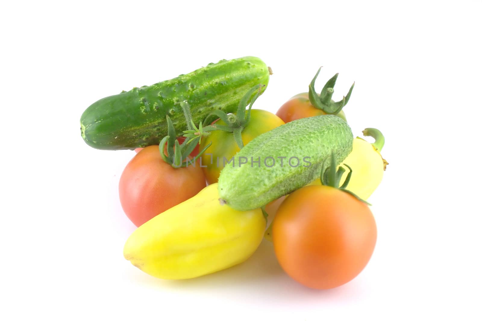 Cucumbers, tomatoes and peppers on white background