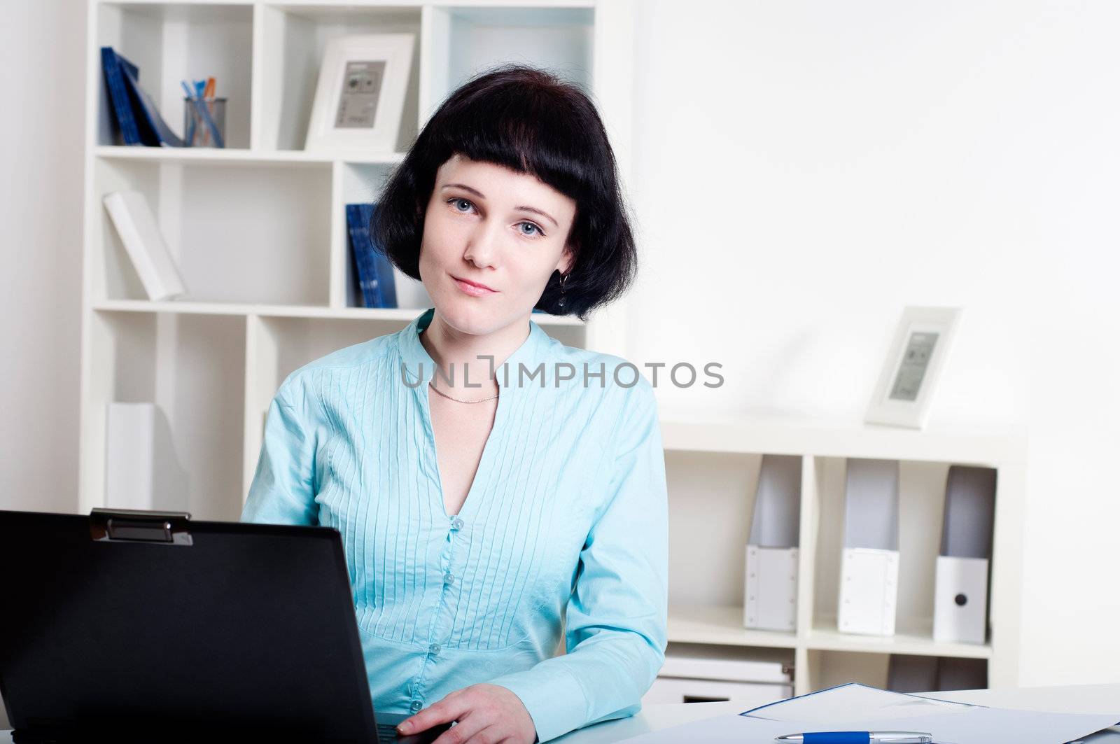 Portrait of a business woman in the office doing some paperwork