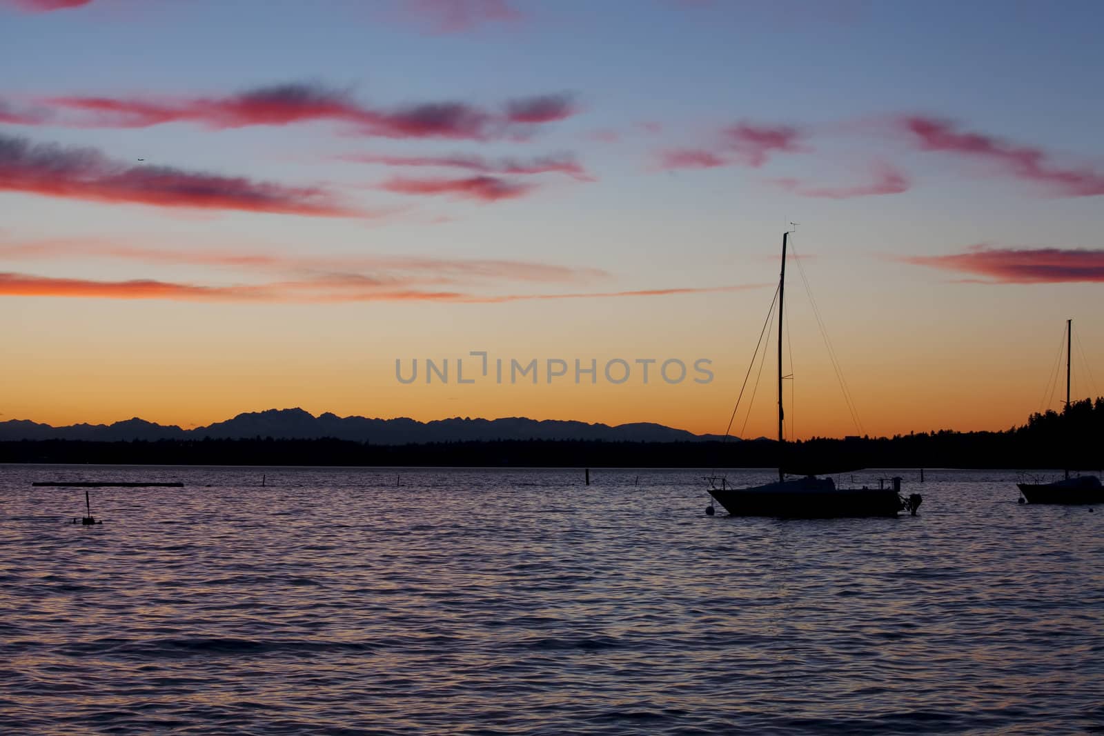 Sunset on lake, focus on boat by jarenwicklund