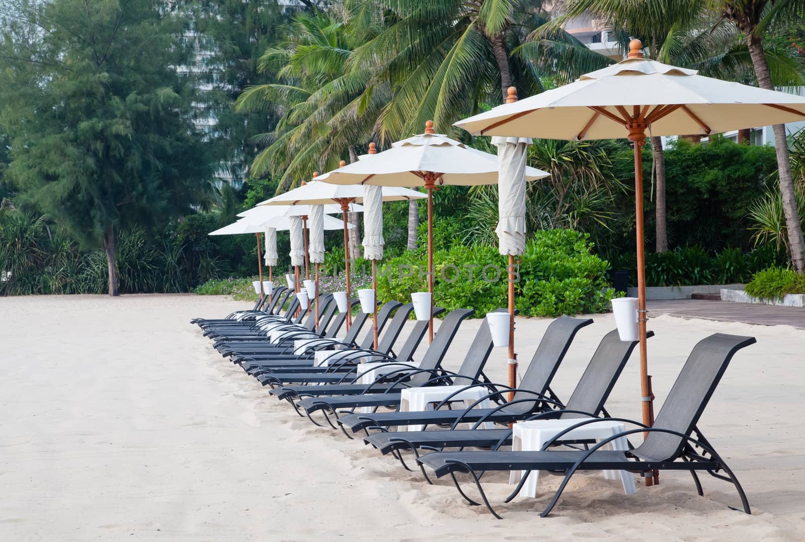 Beach chair and umbrella on tropical sand beach by FrameAngel