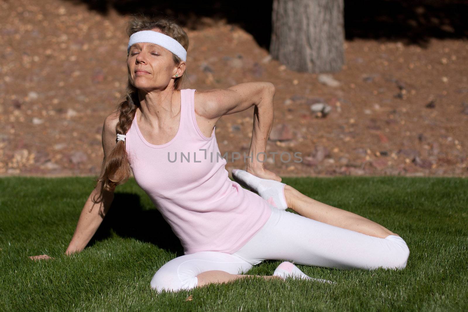 mature women exercising on grass in park