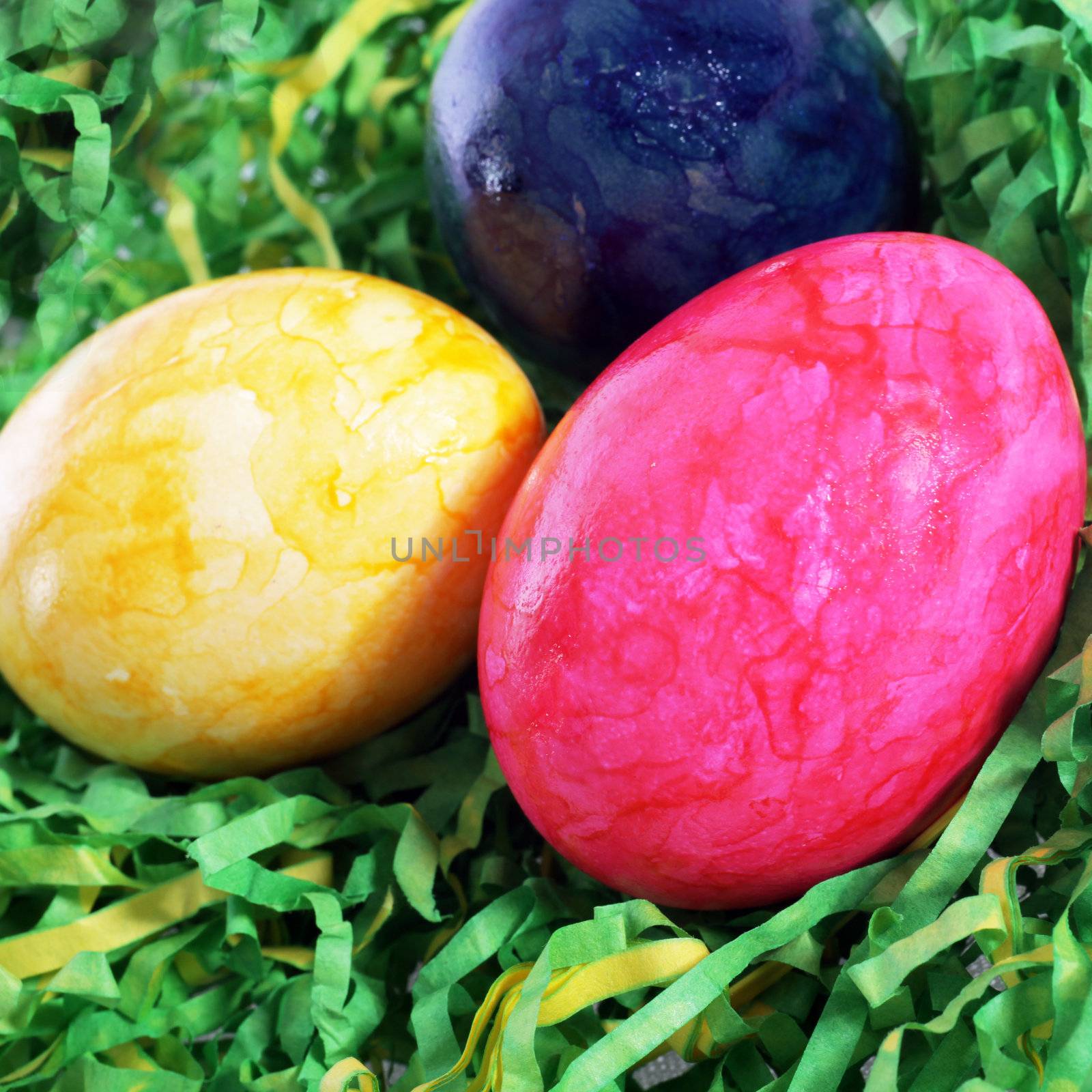 Easter traditional painted eggs in artificial grass, close up