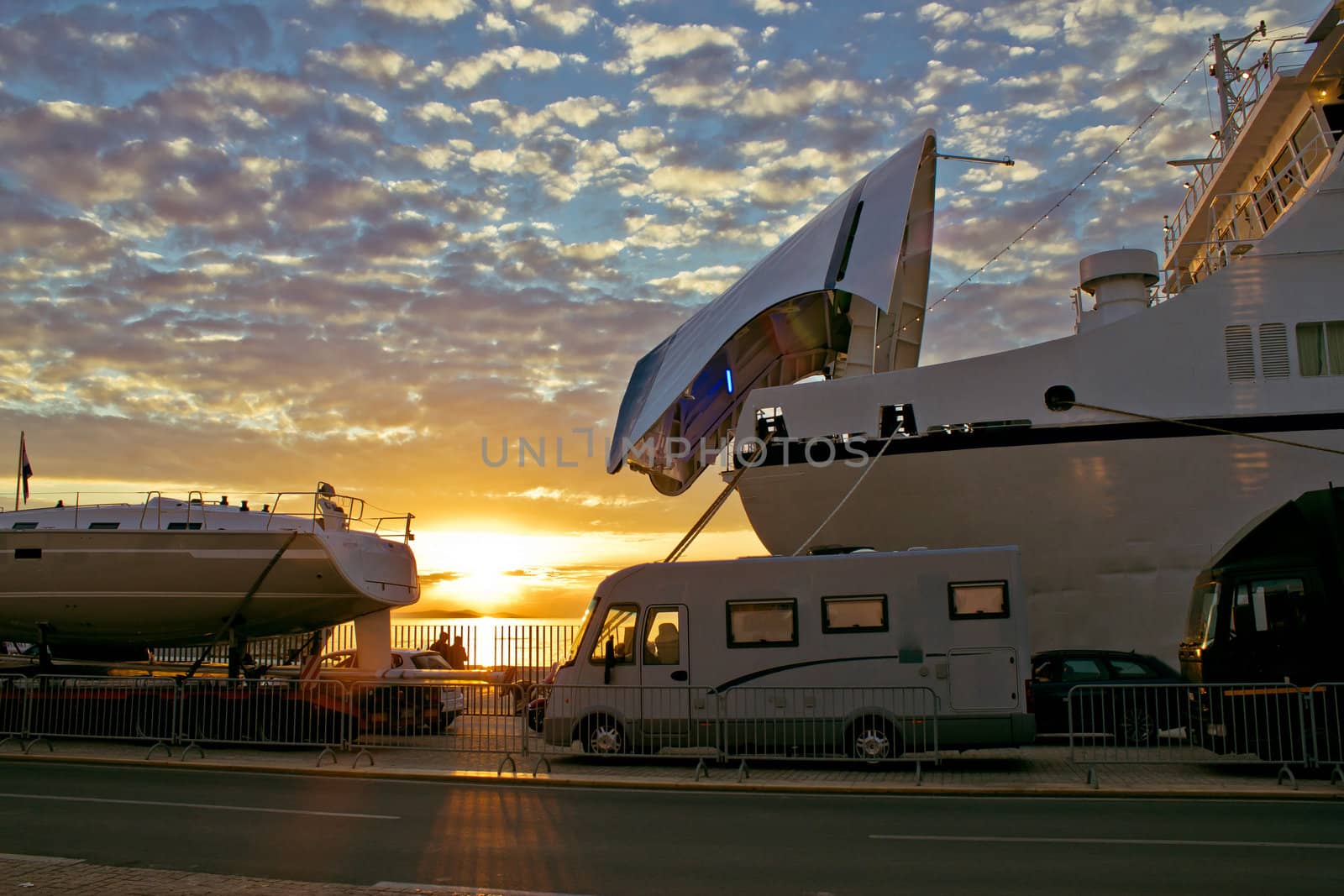 Vehicles waiting on ferry boat docks at sunset, Zadar, Croatia