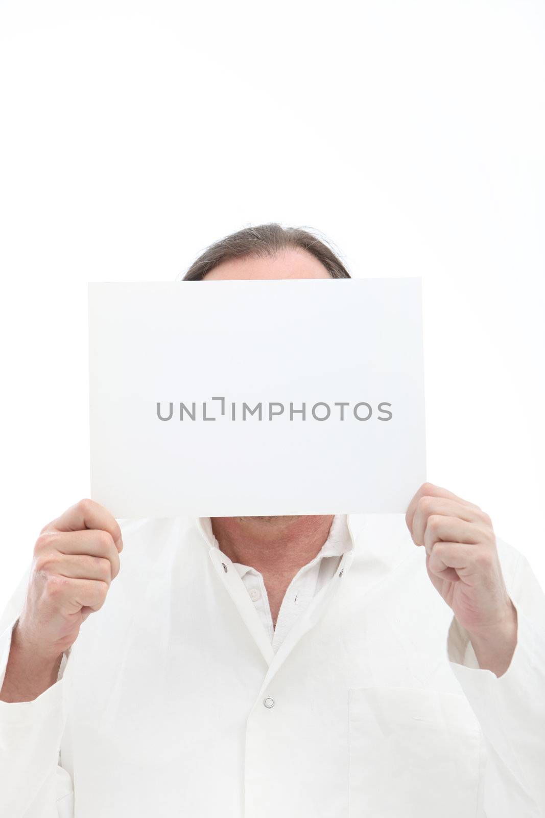 Man holding blank white paper with room for your text or message in front of his face