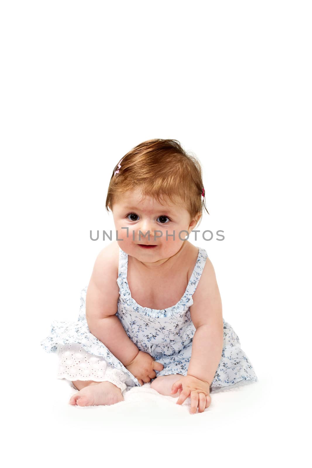 Happy baby sitting on white towel