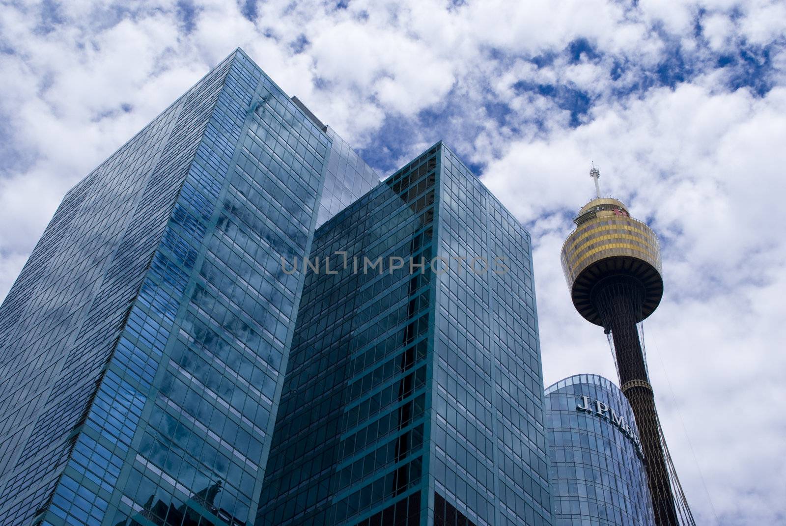 Modern buildings with reflection of clouds on it. Sydney tower.