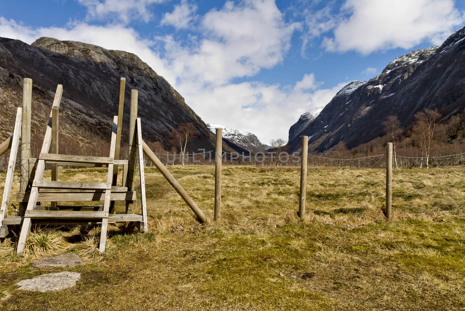 fence with stairs in rural landscape, norway, europe