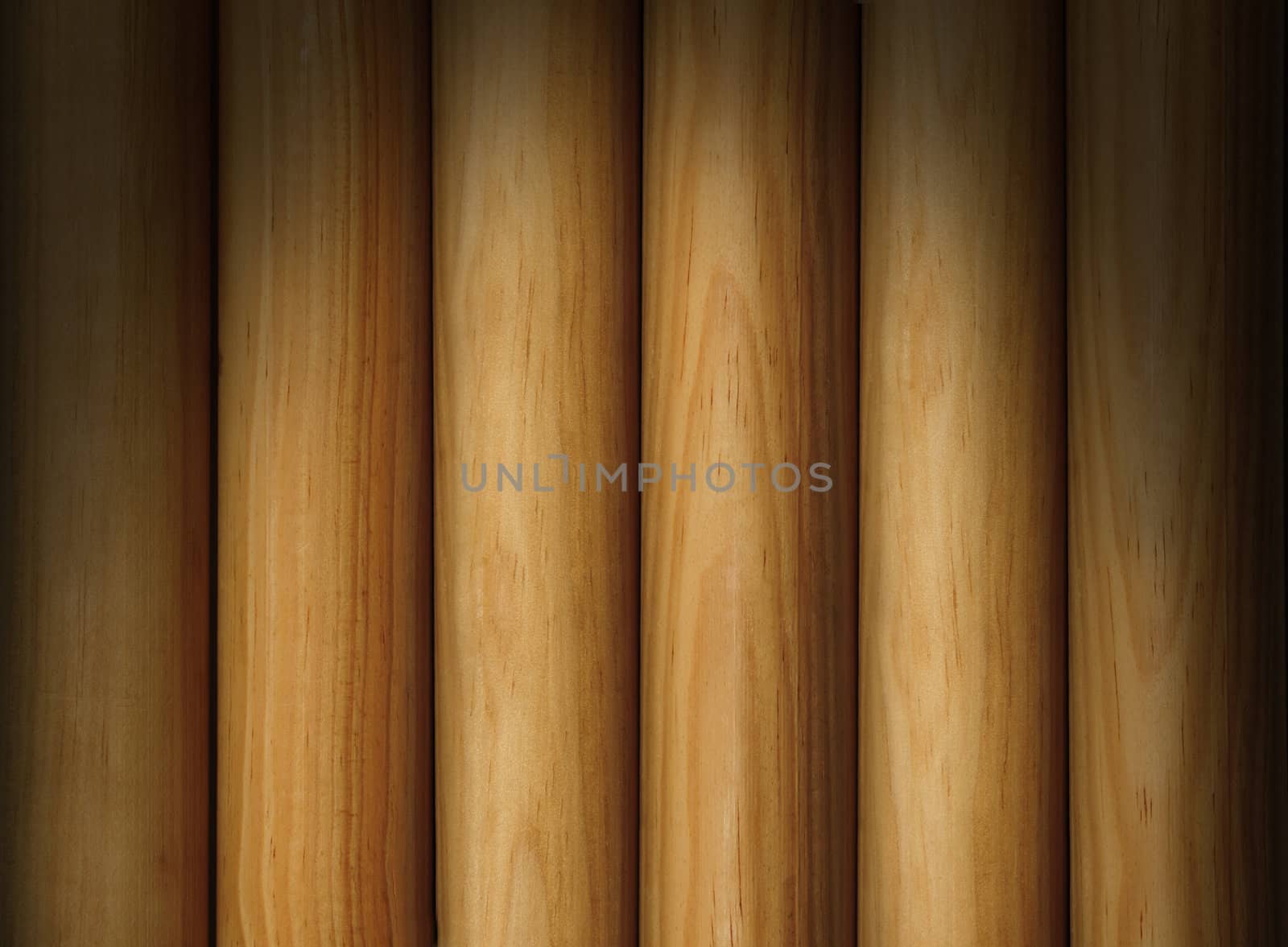 Wooden poles forming a background texture lit dramatically from above