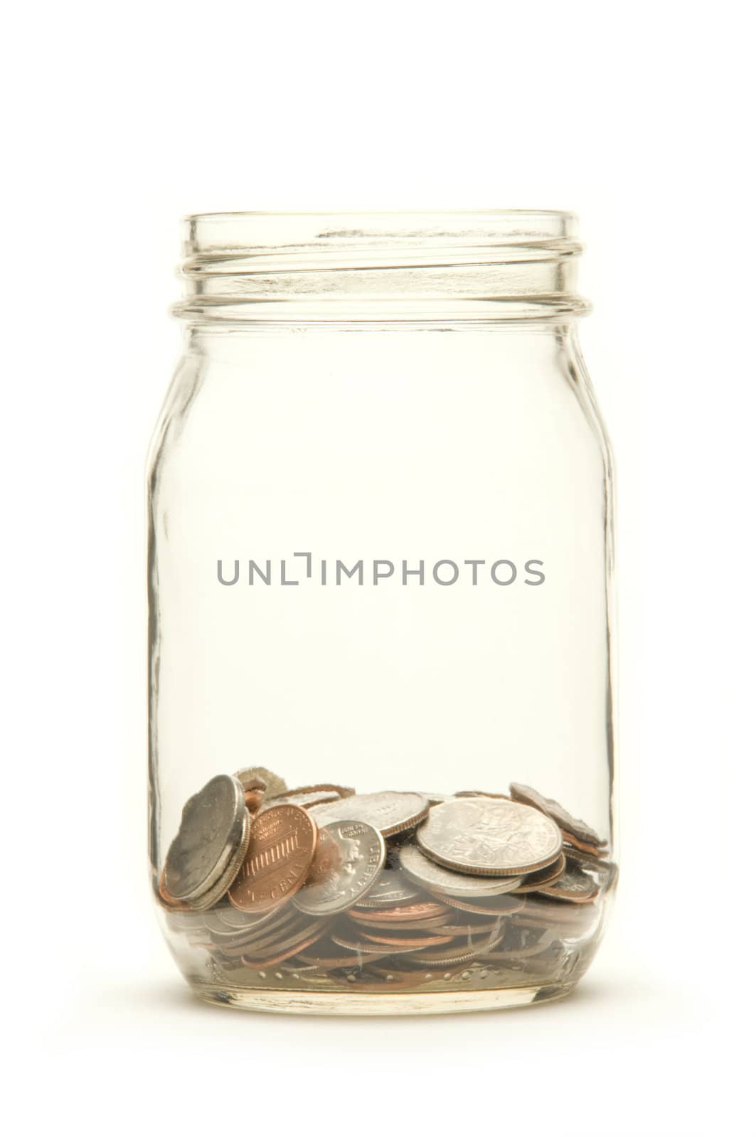 American coins in a glass jar against a white background