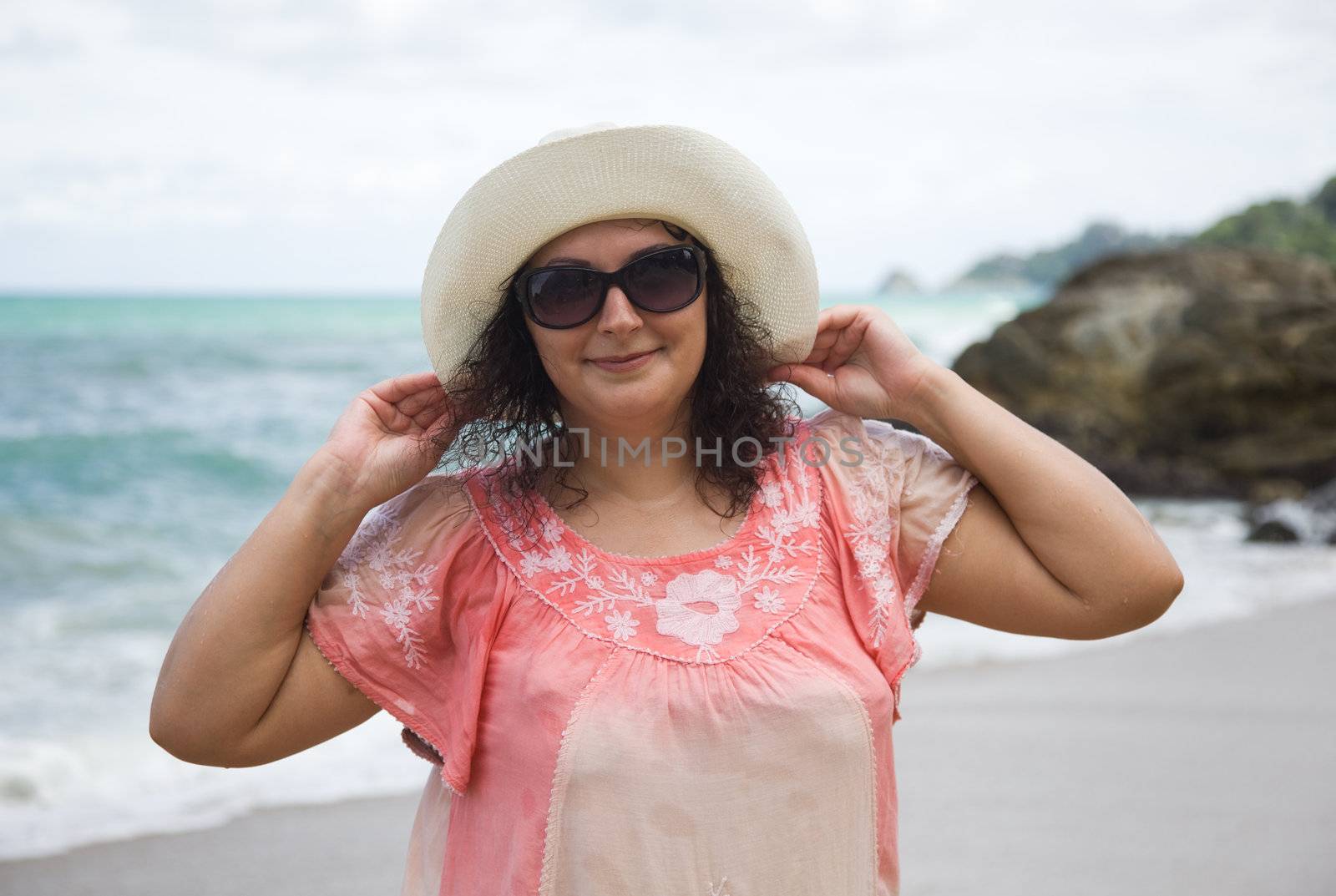 A woman in a white hat and sunglasses on the beach. Thailand. Phuket