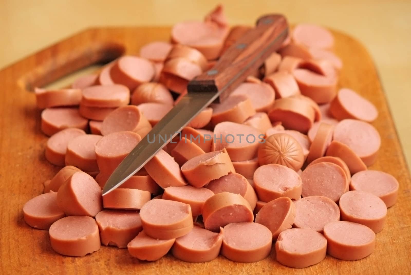 Cutted sausage on a chopping board with a knife
