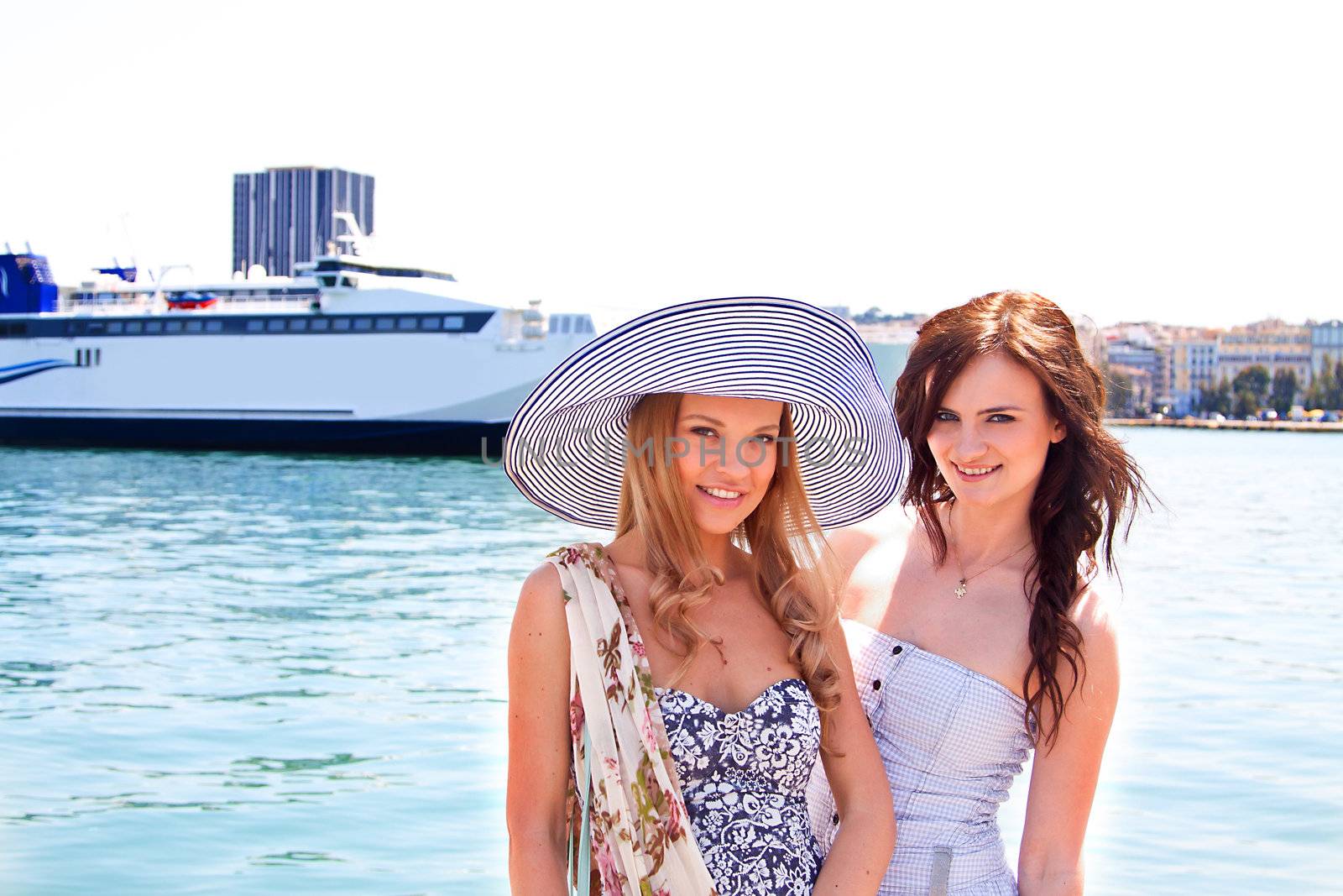 Portrait of a young and beautiful girl in the background of a large ocean liner