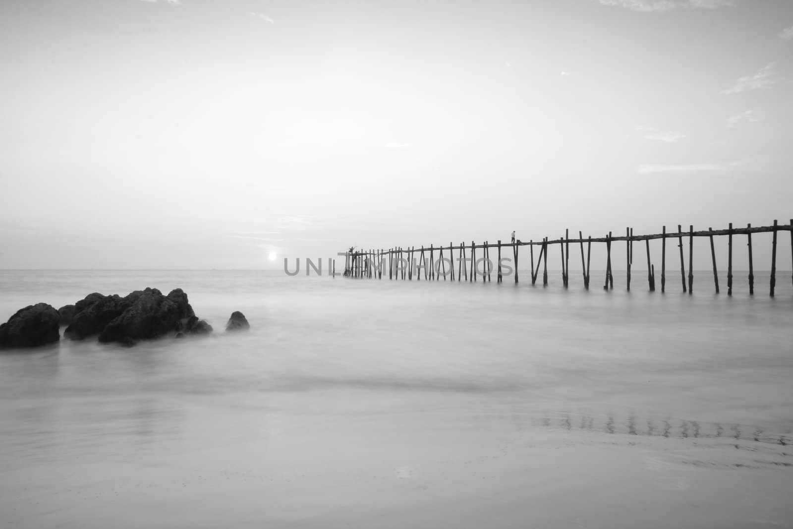 Black and white wood bridge to the sea